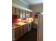 Well-lit kitchen features wood cabinets, stainless steel sink, and granite countertops at 3123 Brassfield Rd, Creedmoor, NC 27522