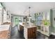 Spacious kitchen boasts a large island, modern appliances, and a cozy dining area at 3123 Brassfield Rd, Creedmoor, NC 27522