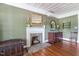 Inviting room showcasing a fireplace, hardwood floors, and vintage decor at 3123 Brassfield Rd, Creedmoor, NC 27522