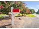 Rural mailbox with the home's address and flowering trees along the road at 3123 Brassfield Rd, Creedmoor, NC 27522
