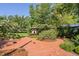 Inviting outdoor area with brick patio, charming gazebo, and surrounding trees and greenery at 3123 Brassfield Rd, Creedmoor, NC 27522