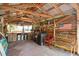 View of the outdoor bar featuring rustic wooden finishes, metal roof and ample seating and workspace at 3123 Brassfield Rd, Creedmoor, NC 27522