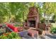 Inviting outdoor brick fireplace with comfortable seating area, perfect for entertaining at 3123 Brassfield Rd, Creedmoor, NC 27522