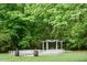 Scenic outdoor wedding venue featuring manicured lawn and an elegant pergola with seating for guests at 3123 Brassfield Rd, Creedmoor, NC 27522