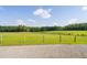 Expansive green pasture with a fence at 3123 Brassfield Rd, Creedmoor, NC 27522