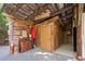Rustic bathroom area with 'Smoke Here' and 'Tinkle Tavern' signs; charming vintage decor at 3123 Brassfield Rd, Creedmoor, NC 27522