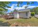A backyard featuring part of a deck, a home exterior and green trees at 316 Waterford Dr, Clayton, NC 27520
