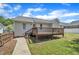 Spacious backyard featuring a deck, grass and a walkway at 316 Waterford Dr, Clayton, NC 27520