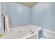Bathroom with a large white tub, neutral color, and a toilet at 316 Waterford Dr, Clayton, NC 27520