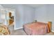 Comfortable bedroom featuring gray carpeting and a glimpse into a kitchen area at 316 Waterford Dr, Clayton, NC 27520