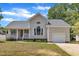 Charming single-Gathering home with a well-manicured lawn, porch, and attached garage in a suburban neighborhood at 316 Waterford Dr, Clayton, NC 27520