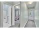 Hallway with neutral walls leading to a bedroom and bathroom with natural light from the door at 316 Waterford Dr, Clayton, NC 27520