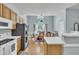 Well-equipped kitchen with stainless steel appliances, wooden cabinets, and a breakfast bar at 316 Waterford Dr, Clayton, NC 27520