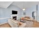 Cozy living room featuring a fireplace, hardwood floors, vaulted ceilings, and comfortable seating at 316 Waterford Dr, Clayton, NC 27520