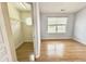 This bedroom has hardwood floors, a window, a closet, and light blue walls at 358 Red Elm Dr, Durham, NC 27713