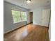 This bedroom features hardwood floors, a window, closet, and light blue walls at 358 Red Elm Dr, Durham, NC 27713