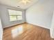 Bedroom with a ceiling fan, hardwood floors, and a large window at 358 Red Elm Dr, Durham, NC 27713
