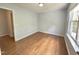 The bright bedroom features hardwood floors, a window, and light blue walls at 358 Red Elm Dr, Durham, NC 27713