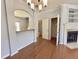 Dining Room view showcasing hardwood floors, chandelier, and access to kitchen and bath at 358 Red Elm Dr, Durham, NC 27713