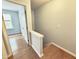 Hallway with hardwood floors, a stairwell, and an adjacent bedroom at 358 Red Elm Dr, Durham, NC 27713