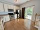 Eat-in kitchen with stainless steel appliances, white cabinetry, and access to a sliding glass door at 358 Red Elm Dr, Durham, NC 27713