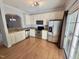 Modern kitchen equipped with stainless steel appliances, light cabinets, and hardwood floors at 358 Red Elm Dr, Durham, NC 27713