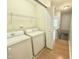 A laundry room with a washer and dryer and closet storage above at 358 Red Elm Dr, Durham, NC 27713