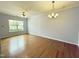 Living room with a ceiling fan, chandelier, hardwood floors, and a window at 358 Red Elm Dr, Durham, NC 27713