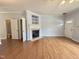 Well-lit living room featuring hardwood floors, a fireplace, and a view to a bathroom at 358 Red Elm Dr, Durham, NC 27713