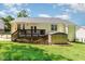 Well-maintained backyard featuring a spacious lawn, wooden deck, and a convenient storage shed at 400 Southerby Dr, Garner, NC 27529