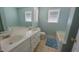 Bright bathroom featuring a double sink vanity, soaking tub, and neutral tile flooring at 400 Southerby Dr, Garner, NC 27529