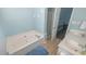 Bathroom featuring a tub, shower, vanity, and an open door to the bedroom at 400 Southerby Dr, Garner, NC 27529