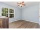 Bedroom with a ceiling fan, a window, and hard surface floors, showing a dresser at 400 Southerby Dr, Garner, NC 27529
