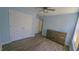 Bright bedroom with double door closet, wood-look flooring, and ceiling fan at 400 Southerby Dr, Garner, NC 27529