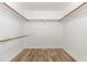A spacious walk-in closet with wood-look flooring, offering ample storage space at 400 Southerby Dr, Garner, NC 27529