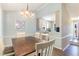 Bright dining area with hardwood floors, white table and chairs, seamlessly connected to the modern kitchen at 400 Southerby Dr, Garner, NC 27529