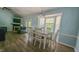 Dining room area with modern flooring, a fireplace, and large bay windows at 400 Southerby Dr, Garner, NC 27529