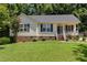Cozy single-story home with a neat front lawn, complemented by a charming front porch and brick foundation at 400 Southerby Dr, Garner, NC 27529