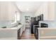 Modern kitchen featuring sleek black appliances, white cabinetry, and ample counter space with hardwood floors at 400 Southerby Dr, Garner, NC 27529