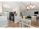 Open-concept kitchen and dining area featuring white cabinets, black appliances, and seamless flow to the living room at 400 Southerby Dr, Garner, NC 27529