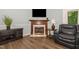 Cozy living room featuring a fireplace, modern entertainment setup, and stylish hardwood flooring at 400 Southerby Dr, Garner, NC 27529