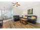 Comfortable living room featuring hardwood floors, stylish furniture, and an open layout to the adjacent dining area at 400 Southerby Dr, Garner, NC 27529