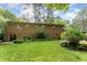 A view of the rear of the property showing the yard, patio, and sliding glass doors at 4017 Huckleberry Dr, Raleigh, NC 27612
