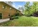 Spacious backyard with green lawn, patio, and mature trees providing shade and privacy at 4017 Huckleberry Dr, Raleigh, NC 27612