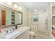 This bathroom has light green walls, a white vanity with a marble countertop, and a large tiled shower at 4017 Huckleberry Dr, Raleigh, NC 27612
