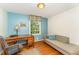 This room features light blue walls, hardwood floors, a couch and a writing desk at 4017 Huckleberry Dr, Raleigh, NC 27612