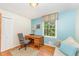 This room features light blue walls, hardwood floors, a couch and a writing desk at 4017 Huckleberry Dr, Raleigh, NC 27612