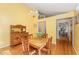 Sunny dining area features hardwood floors and traditional wooden furniture at 4017 Huckleberry Dr, Raleigh, NC 27612