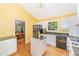 Well-lit kitchen with white cabinetry, granite countertops and stainless appliances at 4017 Huckleberry Dr, Raleigh, NC 27612