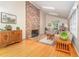 Bright living room with hardwood floors, brick fireplace, and skylights at 4017 Huckleberry Dr, Raleigh, NC 27612
